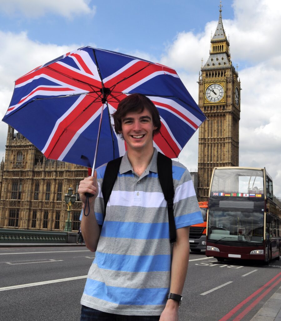 Big Ben and tourist with British flag umbrella in London